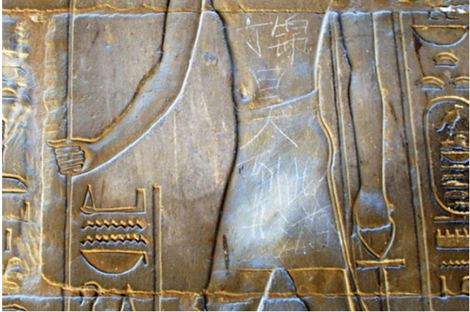 Chinese tourist carve name ancient Egyptian temple. Image from The Wire