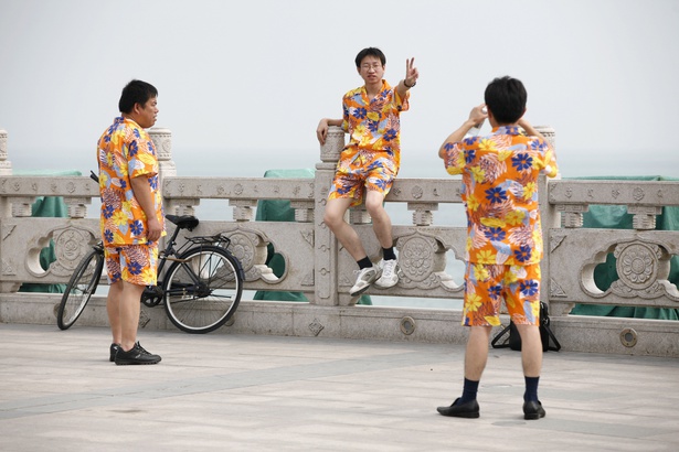 Tourists in awful clothes. Image from Nir Elias on Reuters.