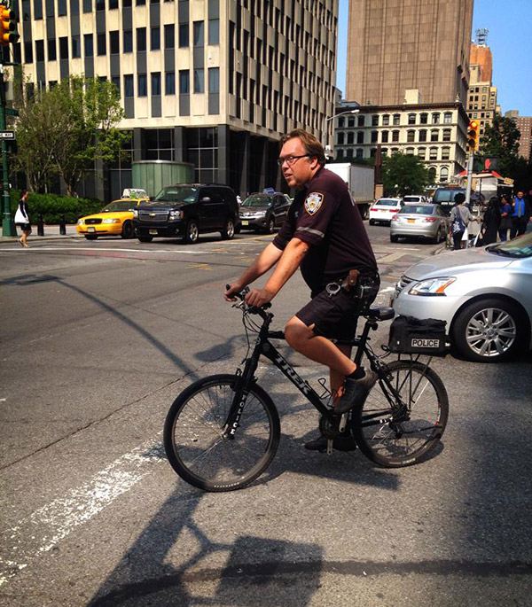 The NYPD patrolling on a bicycle to enforce the Sedition Act... not.