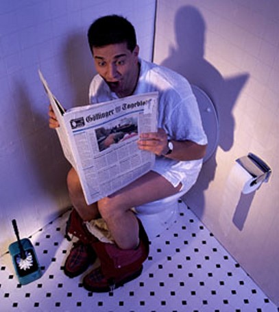 man sitting on toilet reading newspaper. Image from micamyx.com