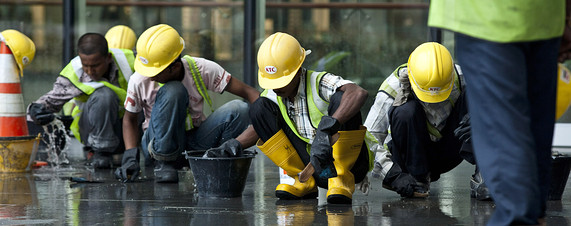 foreign workers scrubbing floor