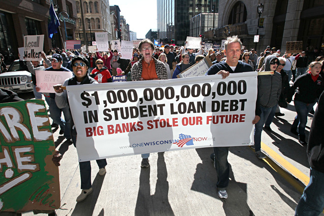 October 15, 2011 Photographs from he Occupy Milwaukee protest and march to the JP Morgan Chase Bank and the M&I Bank in Milwaukee. Here protesters march along N. Water Street past the JP Morgan Chase Bank to the M&I Bank building. This group holding a banner protesting the cost of college loans debt. MICHAEL SEARS/MSEARS@JOURNALSENTINEL.COM