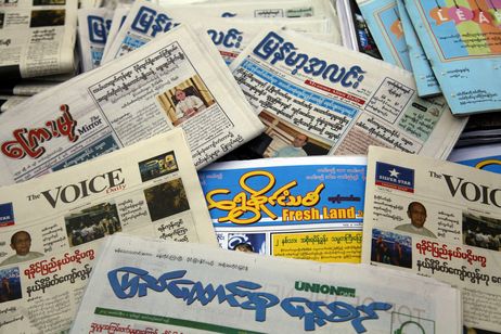 Myanmar daily newspapers are displayed at a roadside shop Monday, April 1, 2013, in Yangon, Myanmar. For most people in Myanmar, it will be a novelty when privately run daily newspapers hit the streets on Monday. Many weren't even born when the late dictator Ne Win imposed a state monopoly on the daily press in the 1960s. (AP Photo/Khin Maung Win)