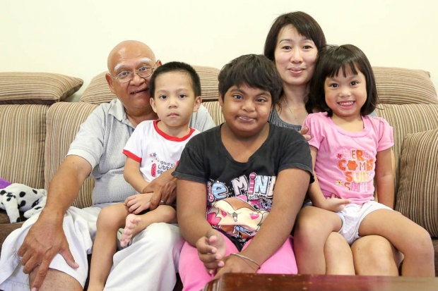 Pastor Henry Martinus and his wife Serena Wong, with their adopted children. Click on image for full story. Image from The Malay Mail Online. 