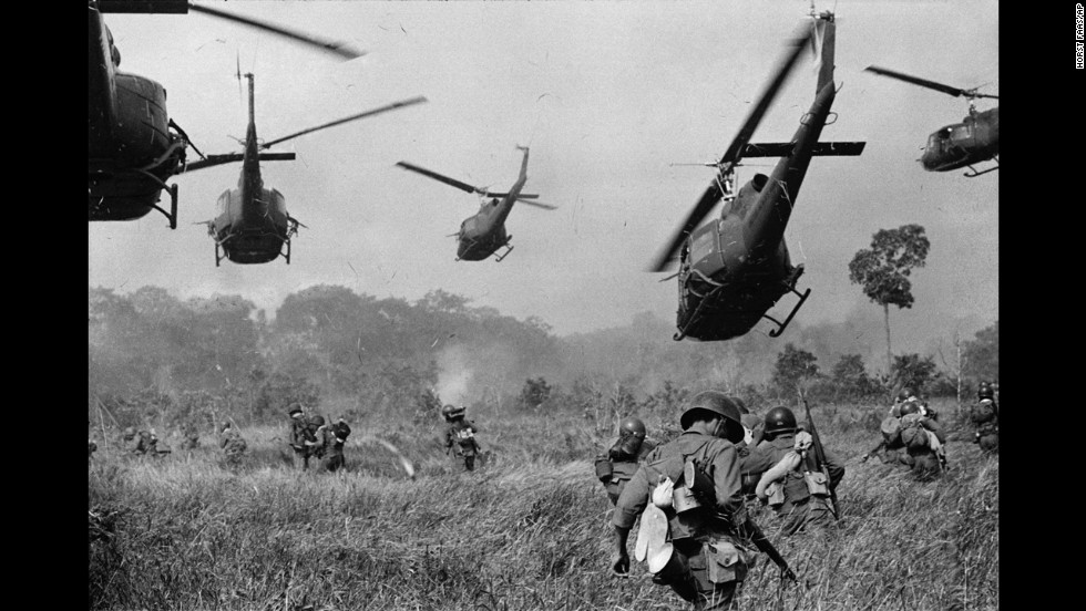 Hovering U.S. Army helicopters pour machine gun fire into the tree line to cover the advance of South Vietnamese ground troops in an attack on a Viet Cong camp 18 miles north of Tay Ninh, northwest of Saigon near the Cambodian border, in March 1965 during the Vietnam War. (AP Photo/Horst Faas)