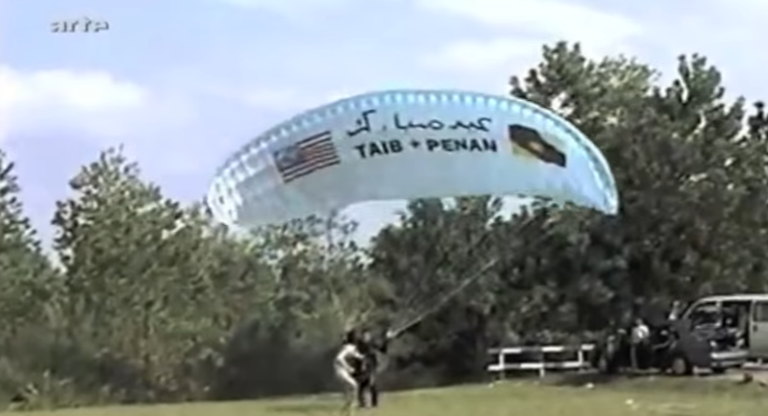 Bruno Manser attempting a paraglide over Chief Minister Taibs residence. Image from Laki Penan