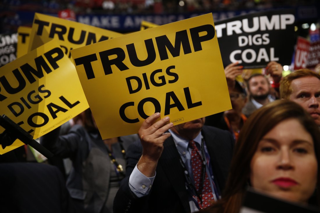 Delegates hold signs reading "Trump Digs Coal" during the Republican National Convention (RNC) in Cleveland, Ohio, U.S., on Tuesday, July 19, 2016. Donald Trump sought to use a speech by his wife to move beyond delegate discontent at the Republican National Convention, only to have the second day open with an onslaught of accusations that his wife's speech lifted phrases from one delivered by Michelle Obama in 2008. Photographer: Andrew Harrer/Bloomberg via Getty Images