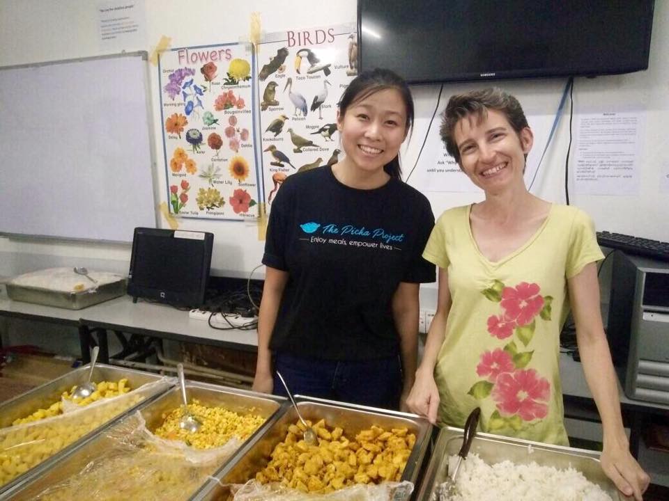 Co-founder Suzanne Ling distributing food at a Burmese refugee school