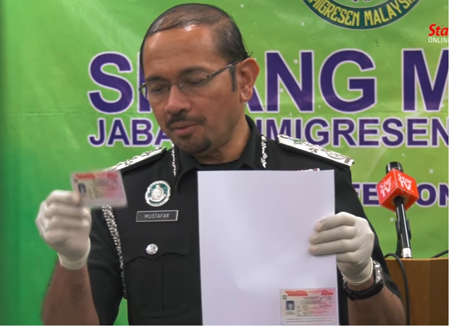 Immigration top man Mustafar Ali showing a fake card