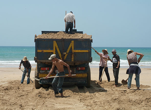 Sand mining in Morocco, a shovel at a time. Img from Coastal Care.