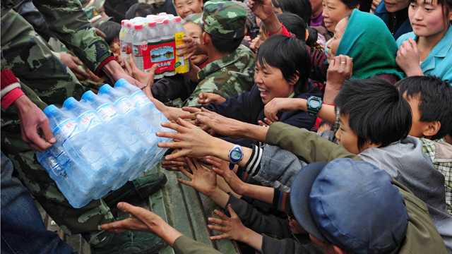 Chinese villagers gather to collect bottled drinking water donated by Beijing residents in Qinglong, in southwest China's Yunnan province on April 4, 2010. China said that more than 24 million people were short of drinking water because of a crippling drought, the worst to hit the country in a century. CHINA OUT AFP PHOTO (Photo credit should read STR/AFP/Getty Images)