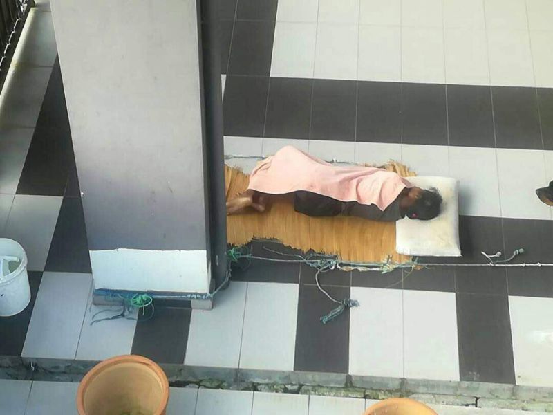 Adelina seen sleeping on the porch of her employer's house. Img by Steven Sim's office, taken from the Malay Mail Online.