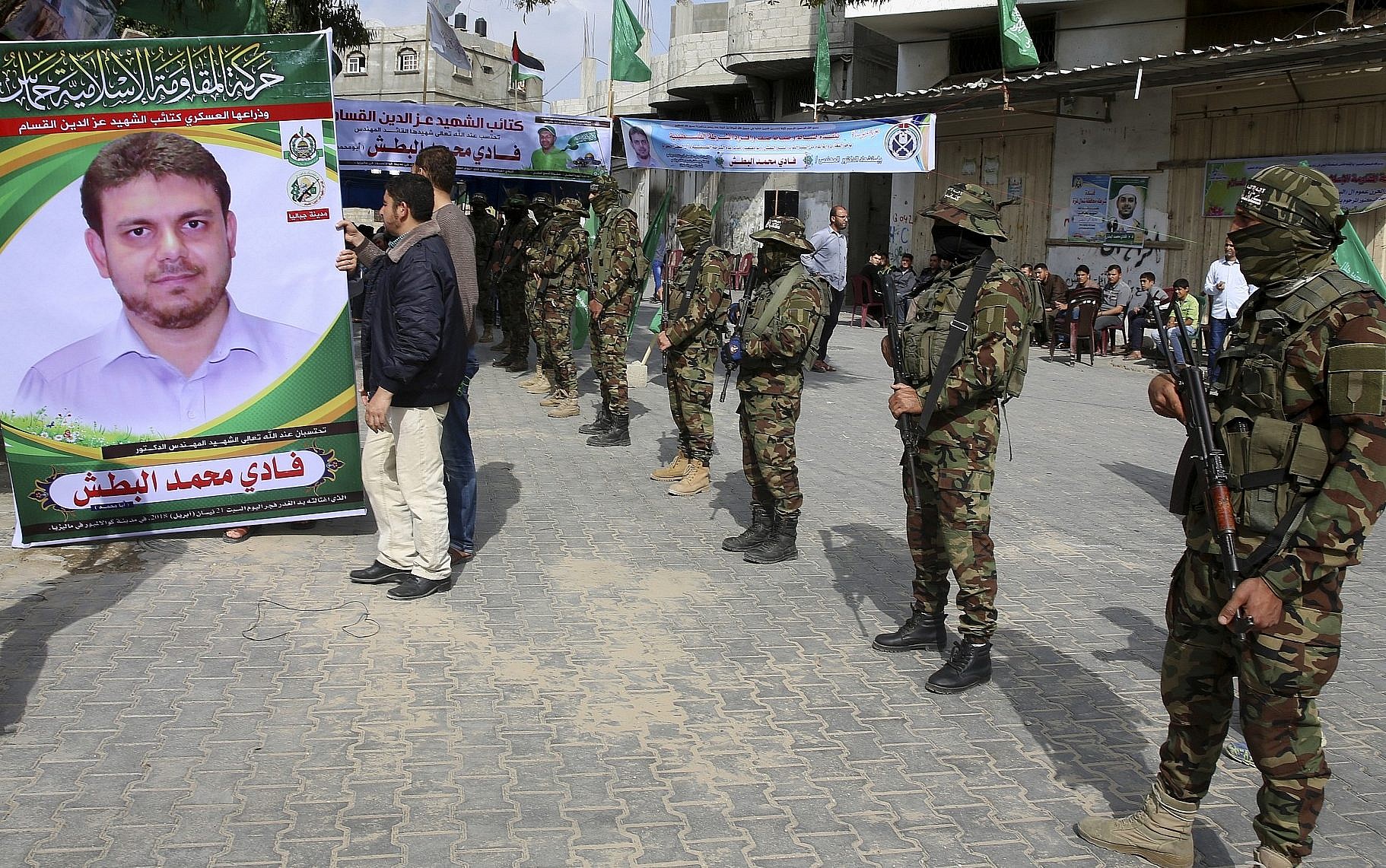 Members of the Qassam Brigades of Hamas in front of Fadi's home in Jabaliya, Palestine. Img from the Times of Israel.
