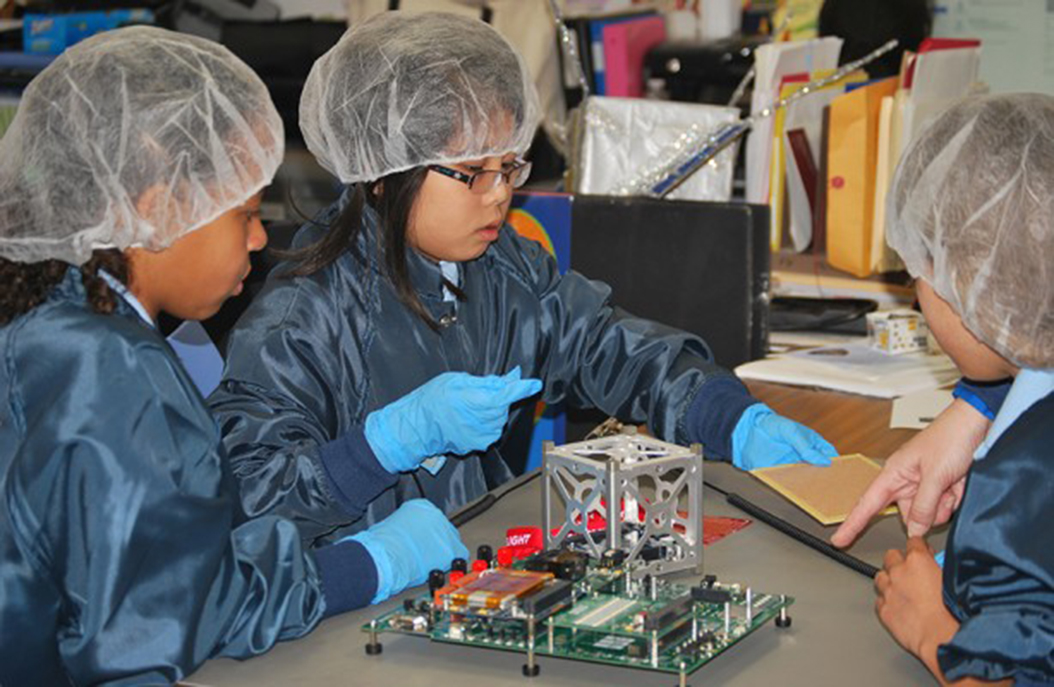 Students from the St. Thomas More Cathedral School in Virginia, US, working on their STMSat-1. Img from NASA.