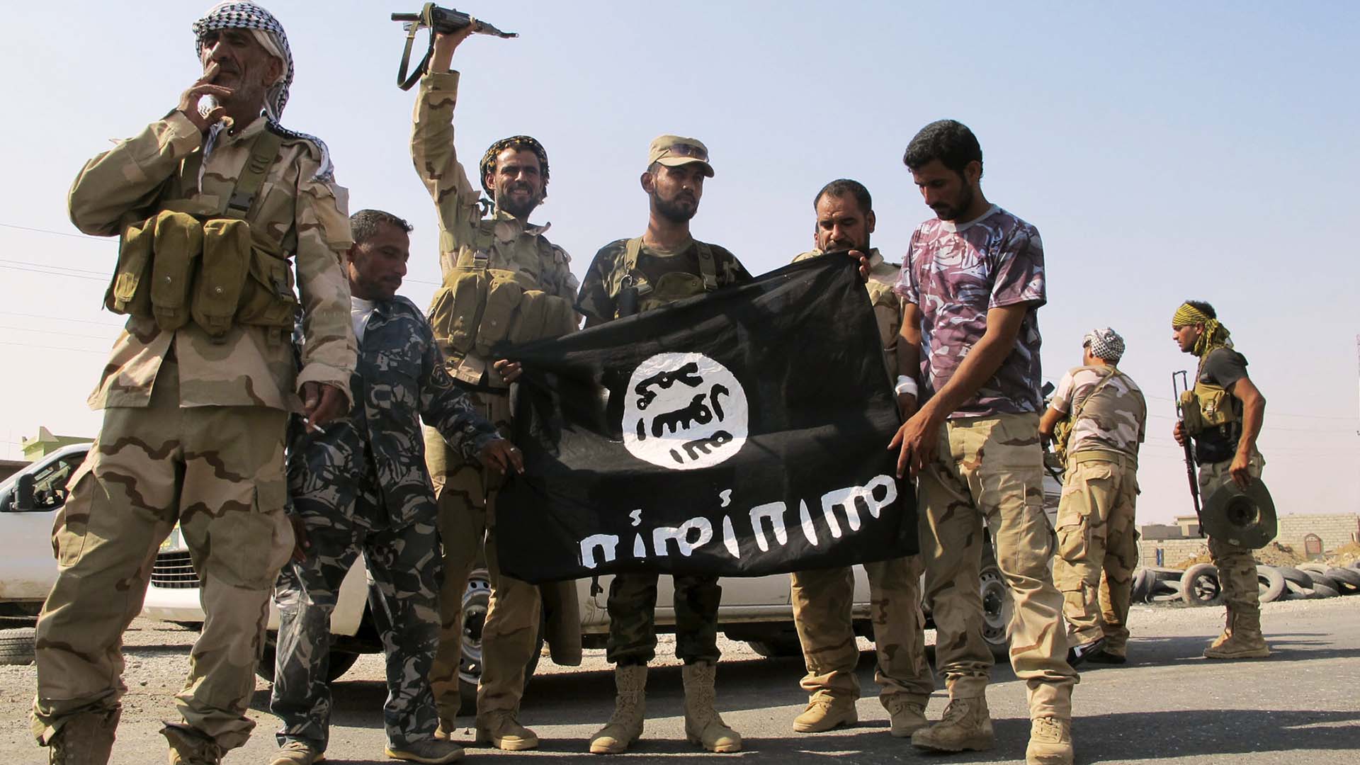 It's trendy to pose with an inverted ISIS flag once you capture their territory. Img from MonsterChildren.
