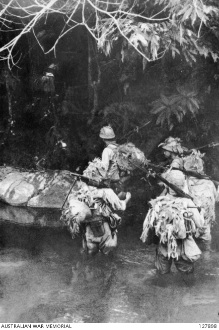Japanese troops crossing a jungle stream. Image from Wikipedia