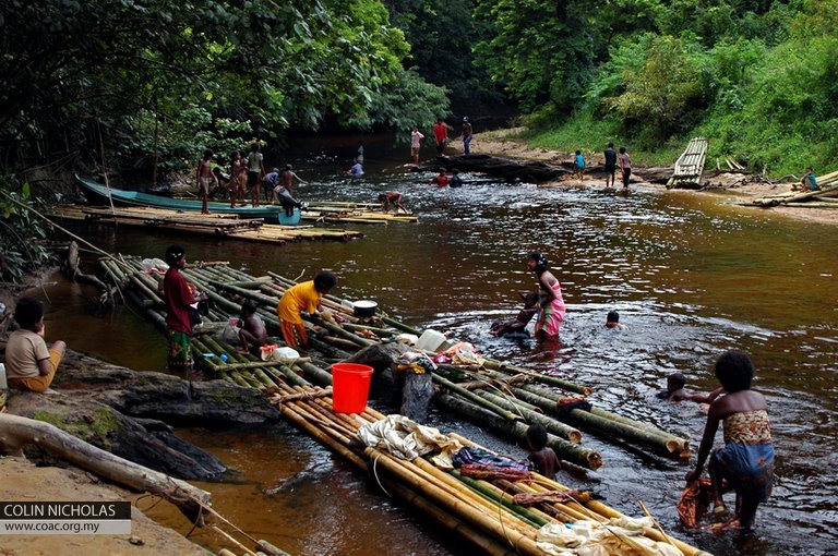Batek people with their rafts by the river. Image from COAC and Colin Nicholas