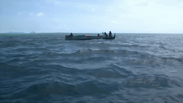 A fisherman throwing a bomb into the ocean to catch fish. GIF from Meeting Malaysia's Fish Bombers