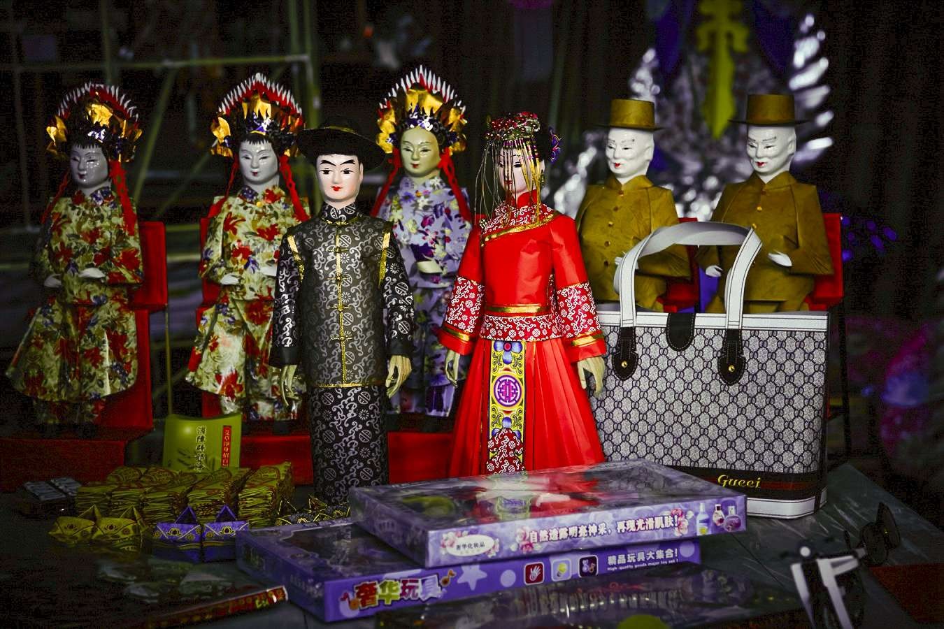 Dolls as representation of the dead couple getting married during a 'ghost marriage' ceremony. Image from SCMP