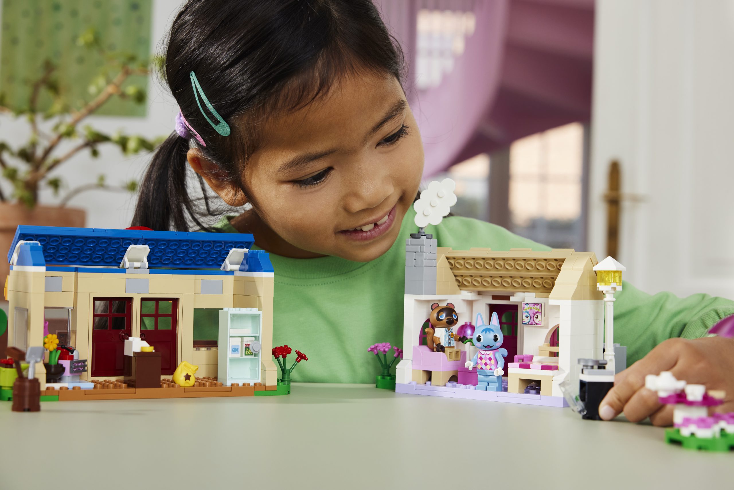 A young girl playing with the LEGO Animal Crossing set