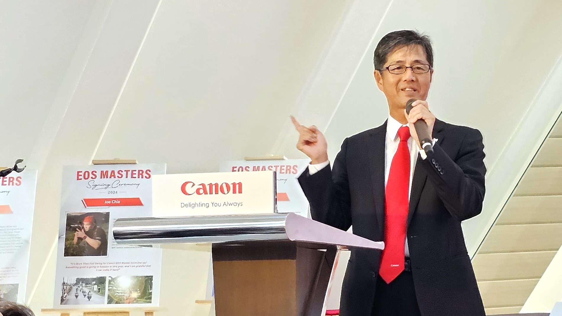 President and CEO of Canon Marketing Malaysia, Masato Yoshiie giving a speech at the 2024 EOS Masters signing ceremony